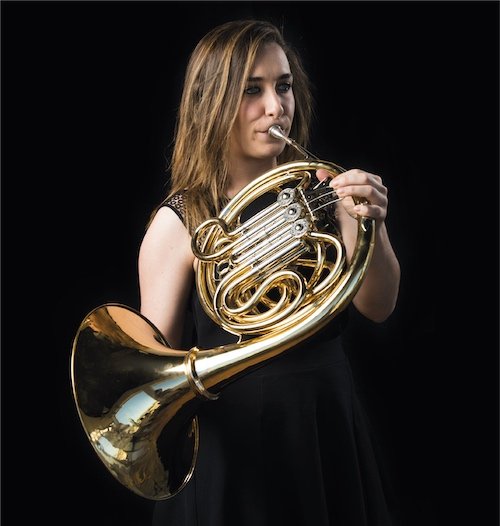 woman playing French horn