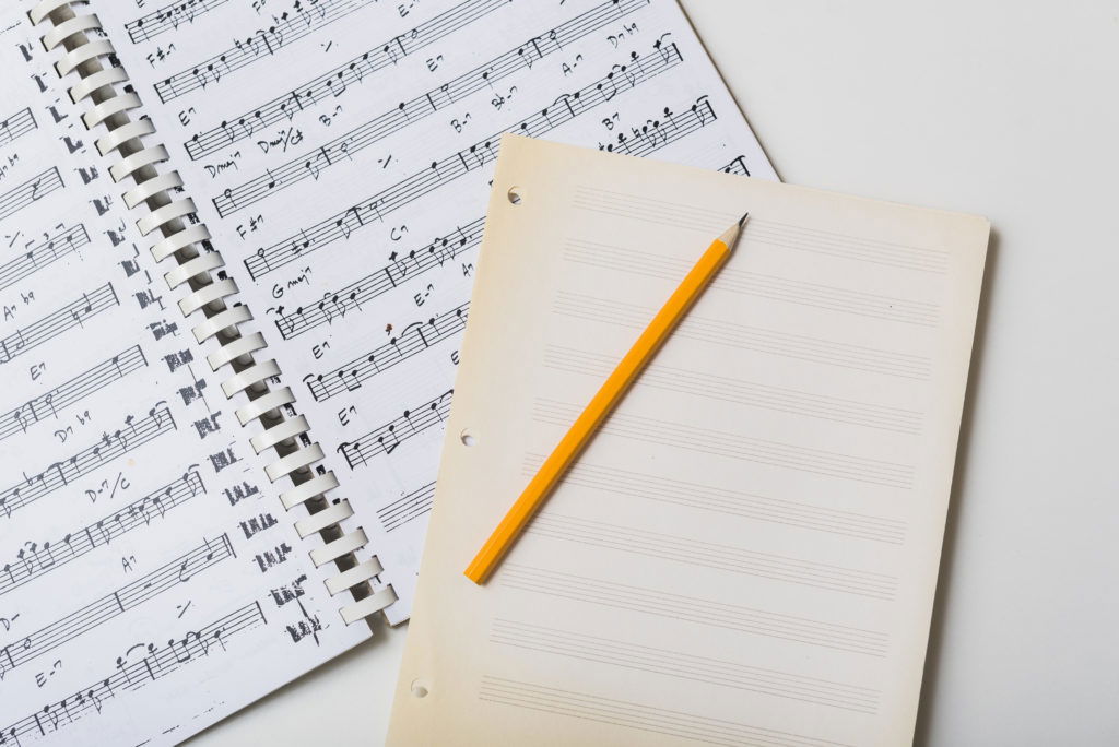 learning music theory, paper, pencil, sheet music