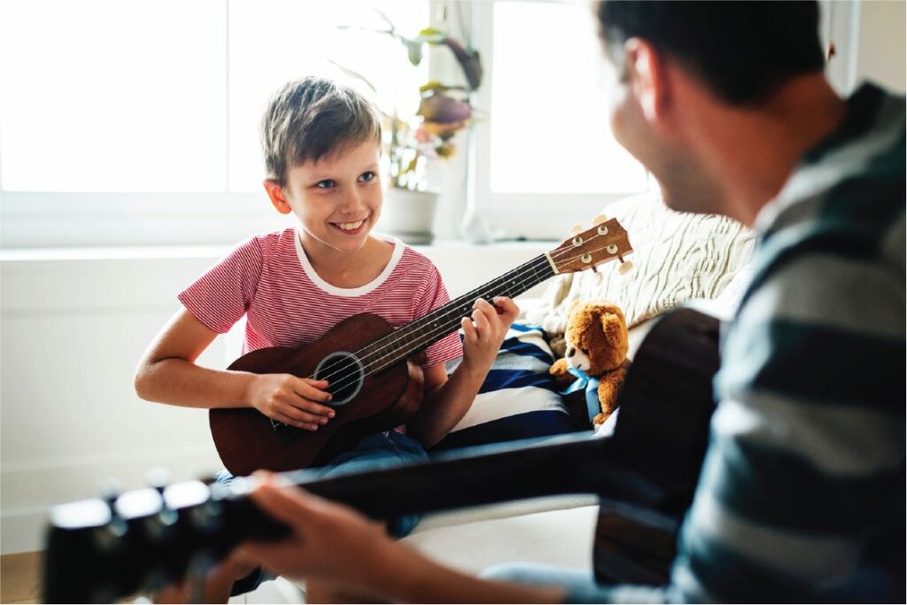 Music teacher with guitar student